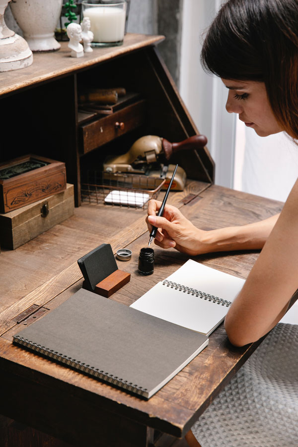 woman-book-pen-ink-desktop
