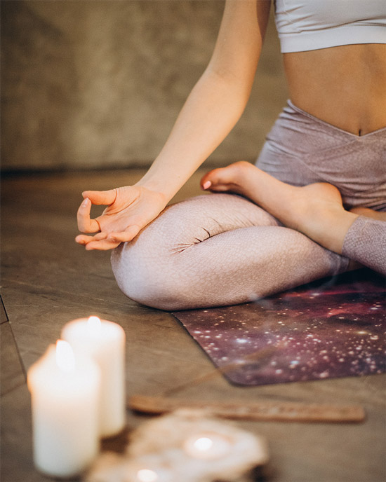 yoga-blog-woman-stretch-meditate-crossed-candle